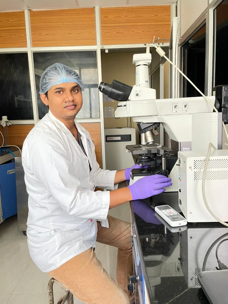 Pathogen Diagnostics team member using microscope testing equipment